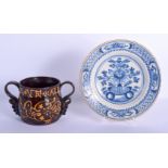 AN 18TH CENTURY DELFT BLUE AND WHITE TIN GLAZED POTTERY PLATE together with an unusual treacle glaze