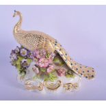 A RARE EARLY 19TH CENTURY DERBY PORCELAIN FIGURE OF A PEACOCK modelled upon an encrusted base. 16 cm