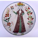 AN UNUSUAL TURKISH OTTOMAN FAIENCE GLAZED PLATE painted with a figure and flowers. 13.5 cm diameter.