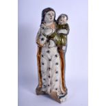 AN 18TH CENTURY FRENCH FAIENCE TIN GLAZED POTTERY FIGURE painted with motifs. 23 cm high.