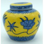 A small yellow ground ginger jar decorated with blue lotus flowers. 9.5cm (2)