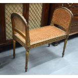 A 19TH CENTURY EUROPEAN CARVED AND PAINTED SOFA FORM PIANO STOOL with wicker upholstery. 68 cm x 72