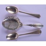 TWO ANTIQUE SILVER SPOONS and a silver straining spoon. 125 grams. Largest 20 cm long. (3)
