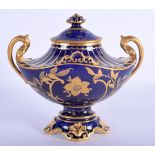 A ROYAL CROWN DERBY TWIN HANDLED VASE AND COVER enamelled with gilded flowers. 13 cm x 12 cm.