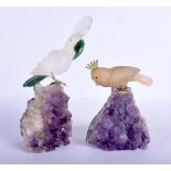 A PAIR OF VINTAGE EUROPEAN CRYSTAL AND AMETHYST FIGURES modelled with birds upon a base. Largest 20