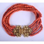 A CHINESE FIVE STRAND CORAL BEAD NECKLACE WITH 18CF GOLD MOUNTS. 35cm long, beads 8mm diameter. 28