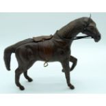 A vintage leather horse possibly French 28 x 37cm .