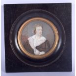 A GEORGE III PAINTED IVORY MINIATURE depicting a male wearing ruffled clothing. Image 8 cm diameter.