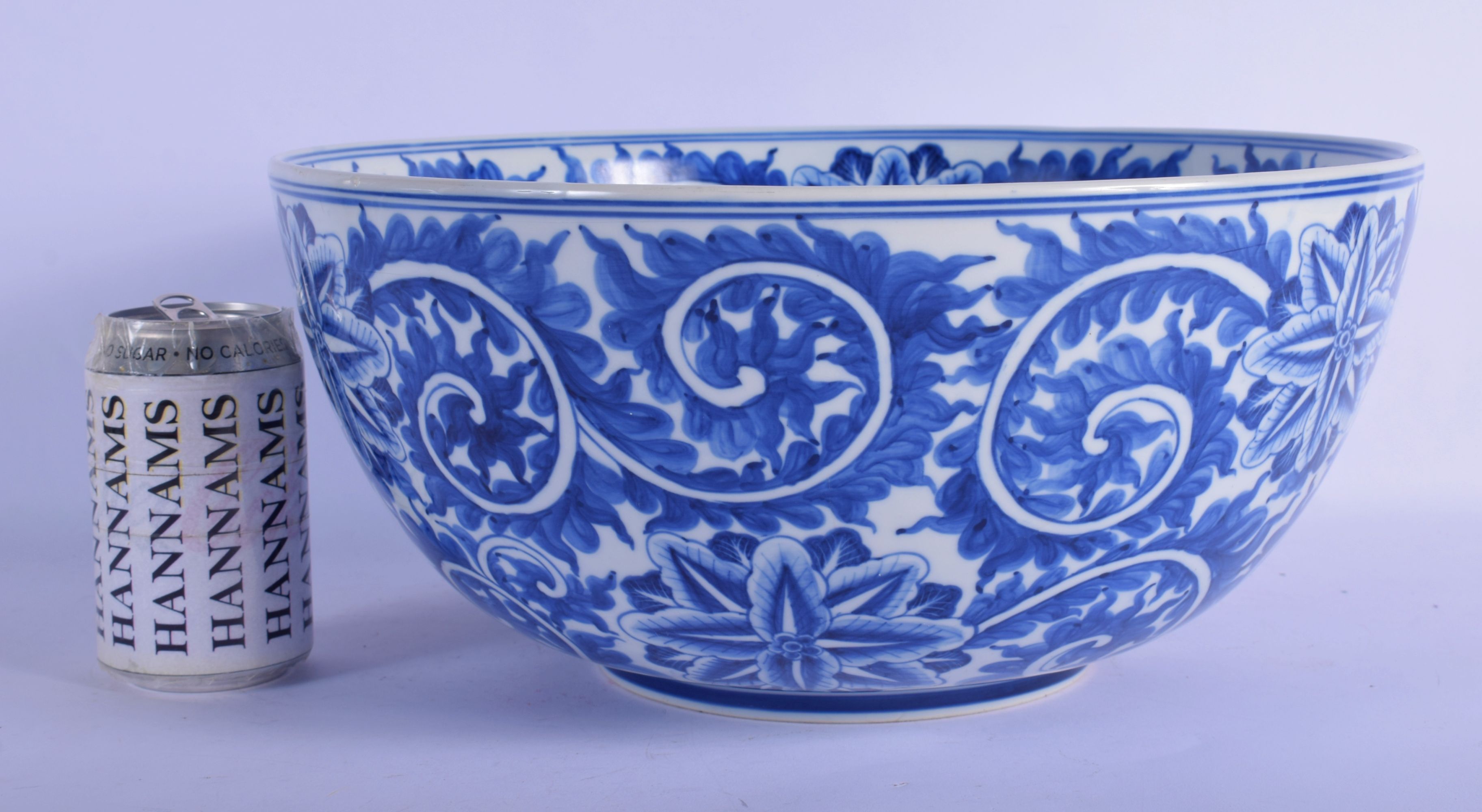 A LARGE 19TH CENTURY CONTINENTAL BLUE AND WHITE PORCELAIN BOWL well painted with bold floral sprays.