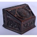A 19TH CENTURY CARVED OAK GOTHIC REVIVAL CRESTED ARMORIAL DESK BOX decorated with motifs. 25 cm x 16