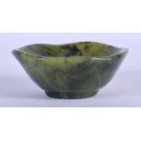 A 19TH CENTURY CHINESE CARVED SPINACH JADE SCALLOPED TEABOWL Late Qing. 5.25 cm wide.