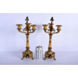 A PAIR OF 19TH CENTURY FRENCH BRONZE AND CHAMPLEVE ENAMEL CANDLESTICKS in the manner of Barbedienne.
