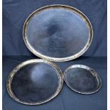 A set of three metal gilt decorated black lacquered graduating trays 71 x 59 cm