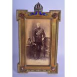 A FINE 19TH/20TH CENTURY EUROPEAN ENAMELLED MILITARY GILT METAL PHOTOGRAPH FRAME formed with a gem s