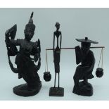 A collection of South East Asian wooden carvings together with a African metal sculpture largest 34c