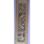AN EARLY 20TH CENTURY CHINESE SILK EMBROIDERED SCROLL decorated with dragons. Silk 68 cm x 11 cm.