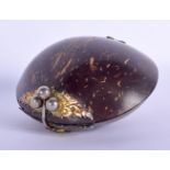 AN ANTIQUE TRIBAL CARVED COCONUT SHELL PURSE with yellow and white metal mounts. 10 cm x 7 cm.