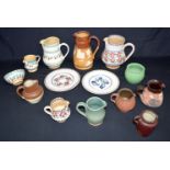 A collection of pottery & terracotta jugs & plates including Royal Doulton salt glaze and Irish Nich