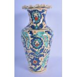 A MIDDLE EASTERN FAIENCE IZNIK TYPE POTTERY VASE painted with floral sprays. 29 cm high.