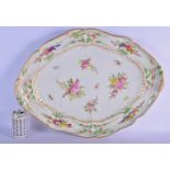 A LARGE ANTIQUE TIN GLAZED POTTERY SERVING TRAY painted with flowers and motifs. 60 cm x 45 cm.