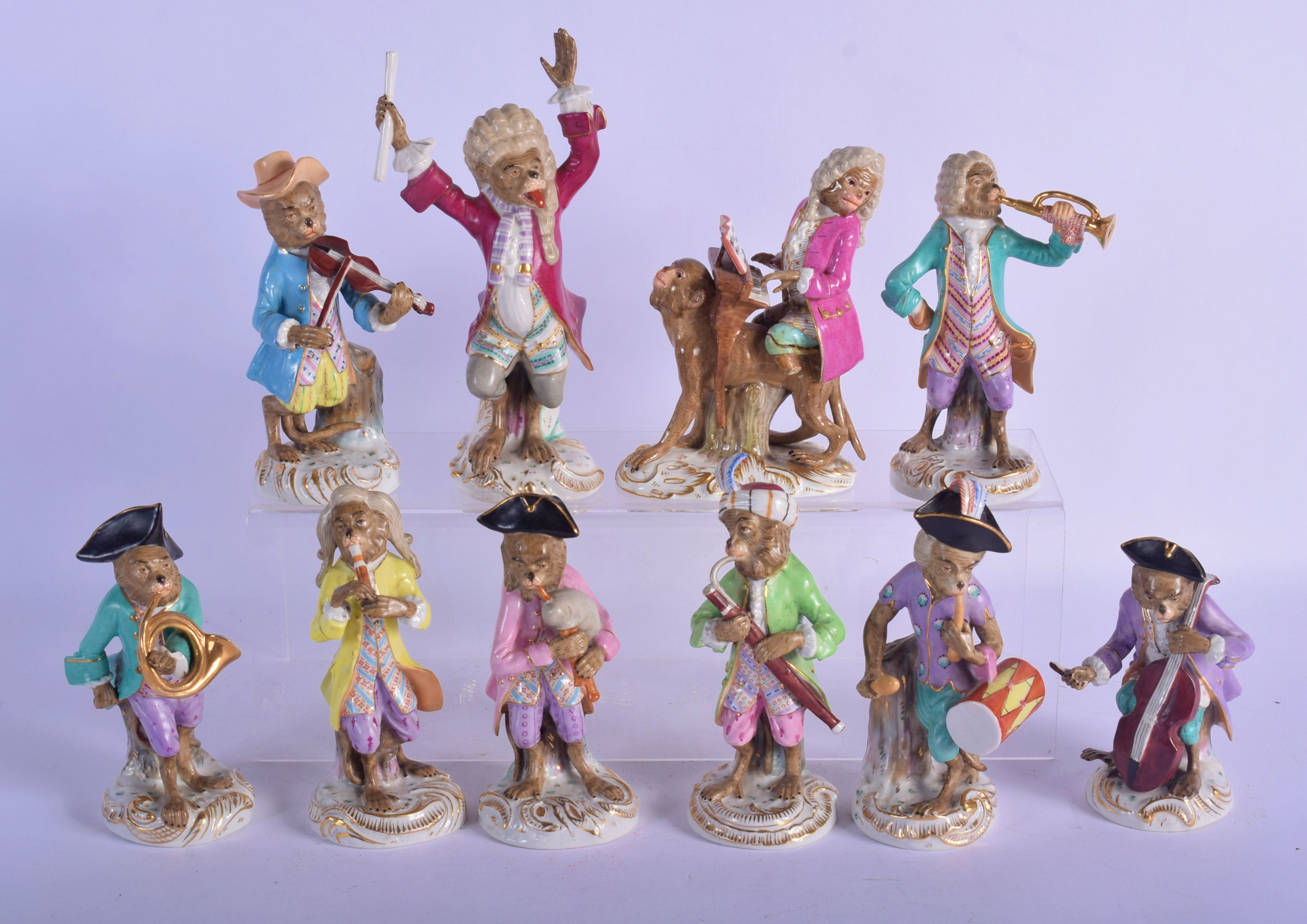 A RARE 19TH CENTURY MEISSEN FIGURE OF A PIANO PLAYER together with nine Dresden monkey musicians. La