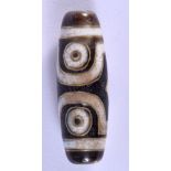 A GOLD INLAY DZI BEAD. 3.7cm long