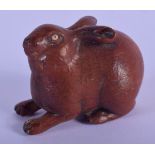 A JAPANESE WOOD NETSUKE CARVED AS A RABBIT. 4.6cm LONG, 3.6cm high, weight 23g