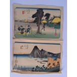 A PAIR OF 19TH CENTURY JAPANESE MEIJI PERIOD WOODBLOCK PRINTS depicting two figures. Image 38 cm x 2