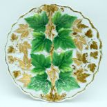 A Meissen porcelain plate decorated in relief with leaves & vines. 25cm