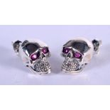 A PAIR OF SILVER SKULL EARRINGS. 1.4cm x 1cm, weight 3g