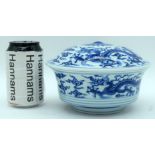 A Chinese blue and white lidded bowl decorated with dragons. 12cm (2)