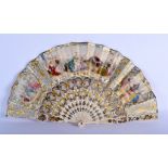 A 19TH CENTURY FRENCH BONE PRINTED AND GILDED FAN decorated with landscapes. 50 cm wide extended.