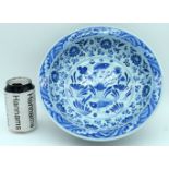 A Chinese porcelain blue and white bowl decorated with lotus and fish. 9 x 26cm