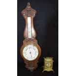 A Mid Century Wooden Barometer together with a metal Chinese themed clock