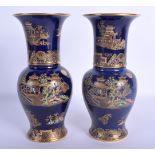 A PAIR OF ART DECO CARLTON WARE BLUE GLAZED VASES enamelled with Chinese landscapes. 20 cm high.
