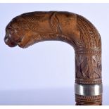 A 19TH CENTURY ANGLO INDIAN CARVED WOOD WALKING CANE with lion head handle, decorated with foliage a