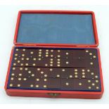 A vintage cased set of Catalin Amber type dominoes 16.5 x 10cm (29).