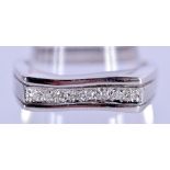 A CONTEMPORARY 9CT WHITE GOLD AND DIAMOND RING. Size N, weight .32g