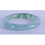 A 20TH CENTURY CHINESE CARVED GREEN JADE BANGLE . 7.5cm Diameter