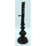 An early iron adjustable candle stick with a wooden base 40cm.