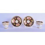 A PAIR OF EARLY 19TH CENTURY ENGLISH PORCELAIN CUPS AND SAUCERS painted with flowers. 11.5 cm diamet