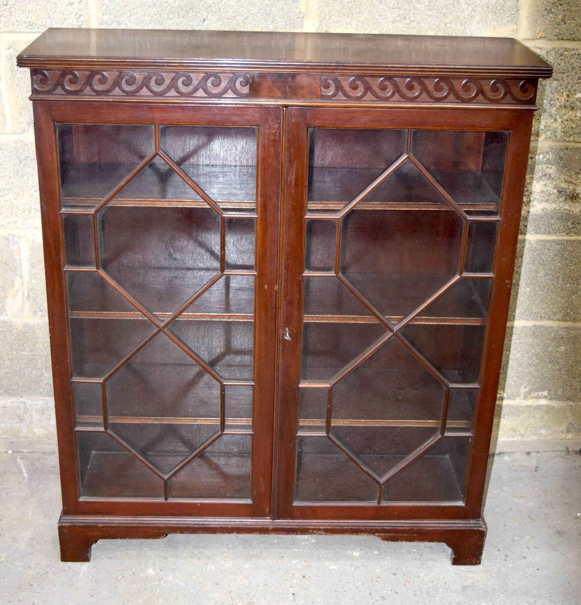 A Mid Century Walnut glass panelled book case 107 x 91 x 29 cm.