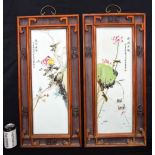 A pair of Chinese hardwood framed porcelain panels decorated with birds and foliage. 71 x 33cm (2)