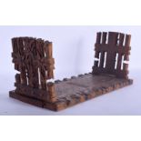 A 19TH CENTURY BAVARIAN BLACK FOREST SLIDING WOOD BOOK RACK formed with foliage and gate posts. 46 c