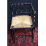 An antique Bobbin turned corner chair with reed work seat 67 x 39cm.
