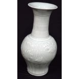 A large Chinese porcelain Celadon vase decorated in relief with flowers 43cm.