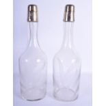 A PAIR OF VINTAGE SILVER TOPPED GLASS THISTLE DECANTERS. 32 cm high.