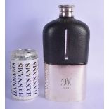 A VERY UNUSUAL LARGE 1920S SILVER PLATED LEATHER HIP FLASK decorated with a central monogram. 23 cm