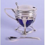 A SILVER MUSTARD POT WITH BLUE GLASS LINER AND SPOON. Hallmark Birmingham 1933, 8cm x 7cm, weight w