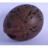 A 19TH CENTURY CONTINENTAL CARVED BUG BEAR COCONUT decorated with figures and foliage. 12 cm x 8 cm.